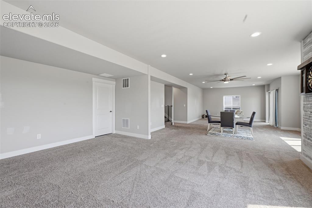 Image 24 of 31: The entrance to the family room from the stairs. And, yet another large cei