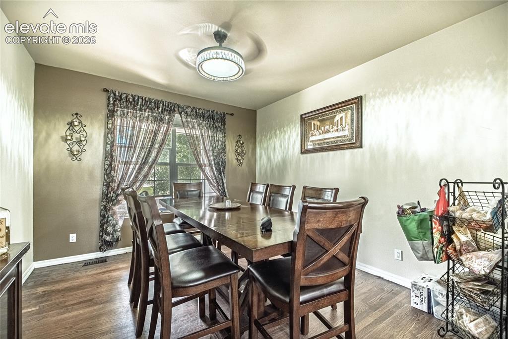 Image 12 of 48: Dining area featuring wood-finish flooring, a window with natural light, an