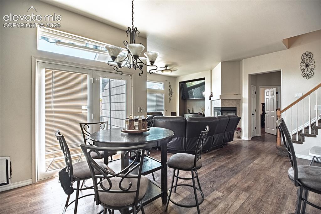 Image 14 of 48: Spacious room featuring wood-finish flooring, a built-in fireplace, and a l