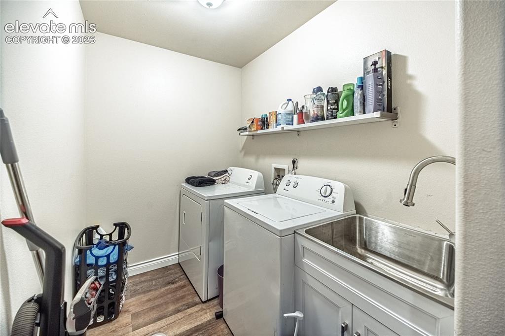 Image 19 of 48: Dedicated laundry space featuring a utility sink with a high-arch faucet, w