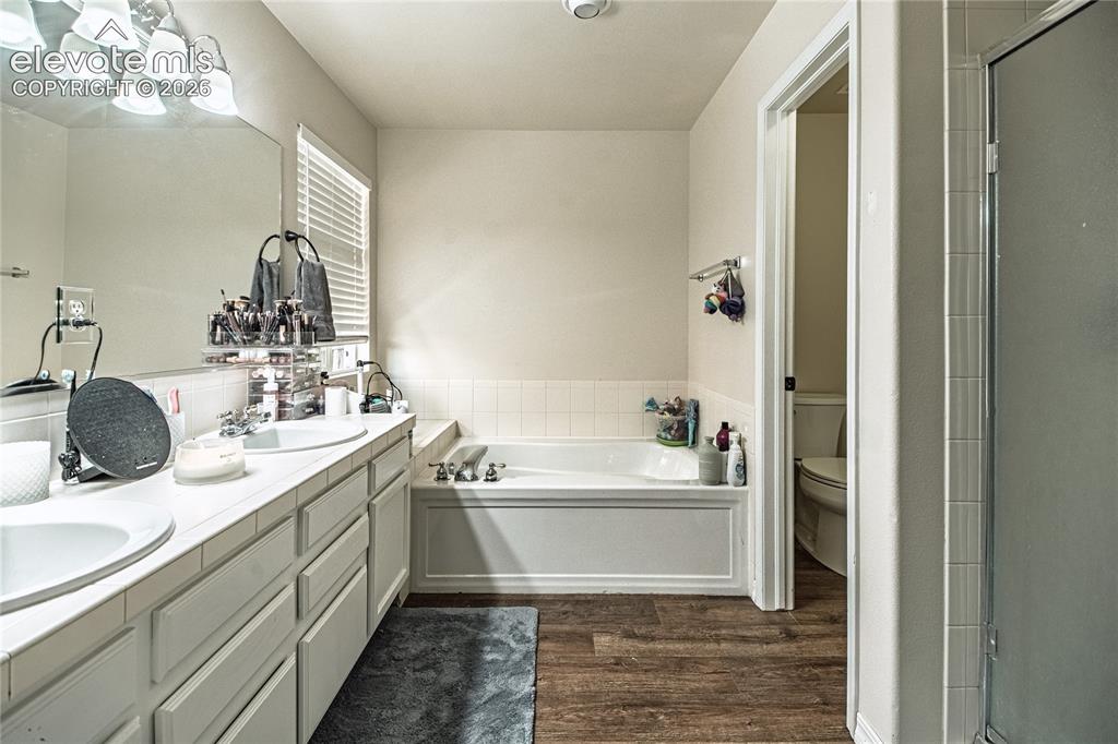 Image 25 of 48: Dual vanity with white tile countertop and integrated sinks