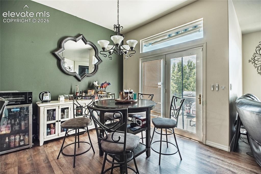 Image 4 of 48: Dining area featuring a decorative chandelier, wood-finish flooring, and Fr