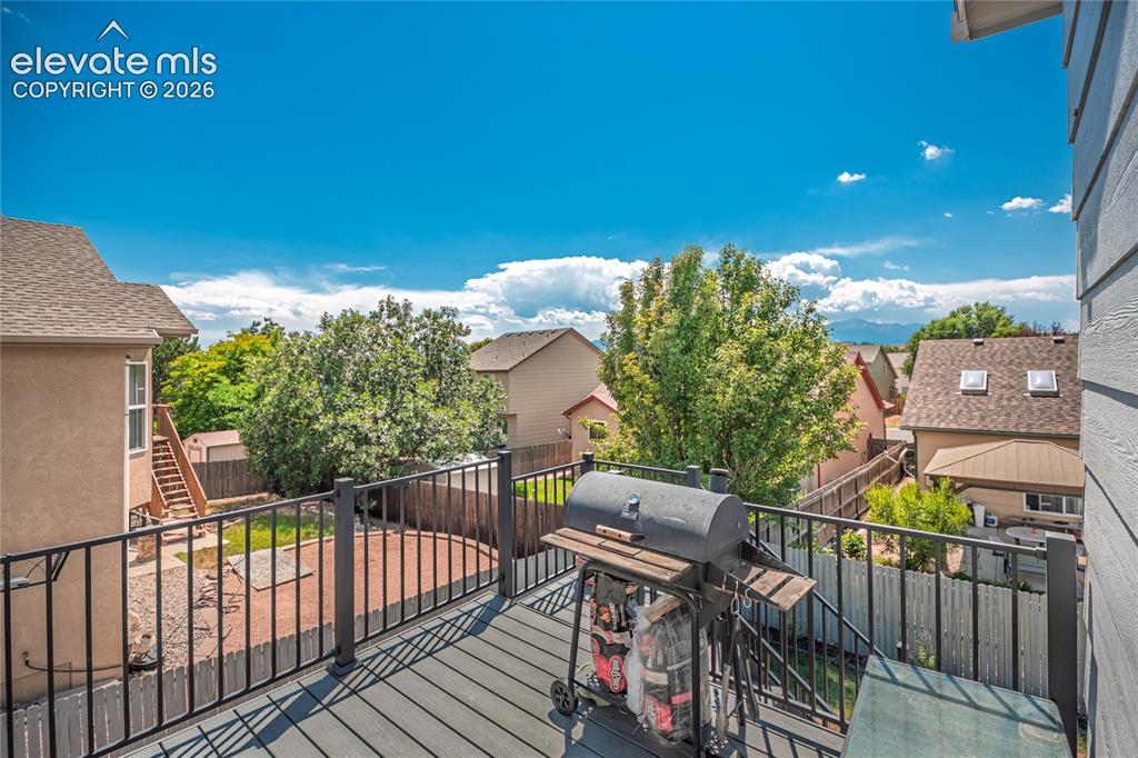 Image 44 of 48: Spacious outdoor deck featuring composite decking and black metal railings