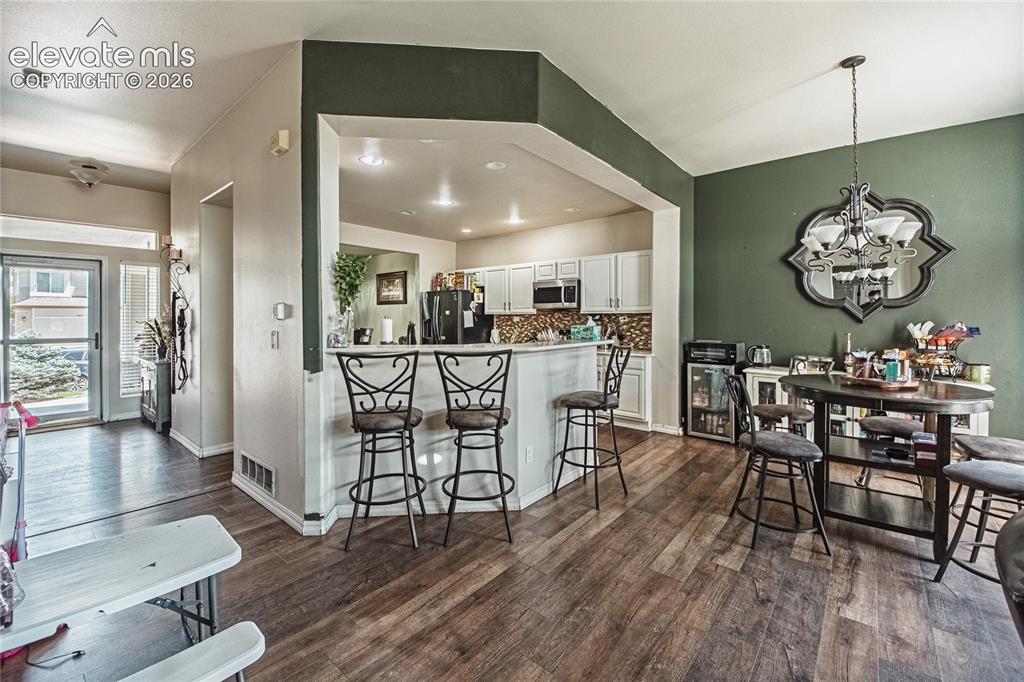 Image 5 of 48: Open-concept living space featuring wood-finish flooring throughout