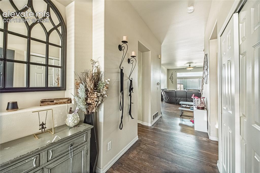 Image 7 of 48: Entryway featuring wood-finish flooring, light-toned walls, and a white pan