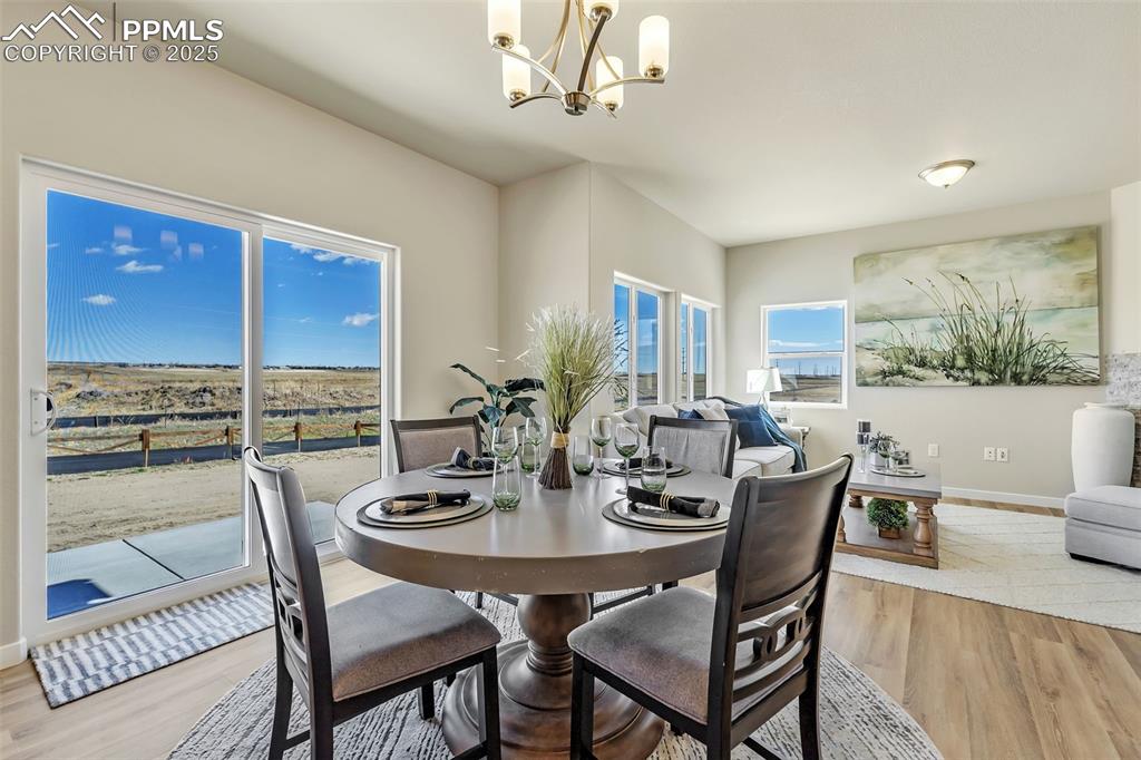 Image 13 of 46: Dining room featuring light wood-style floors and a chandelier