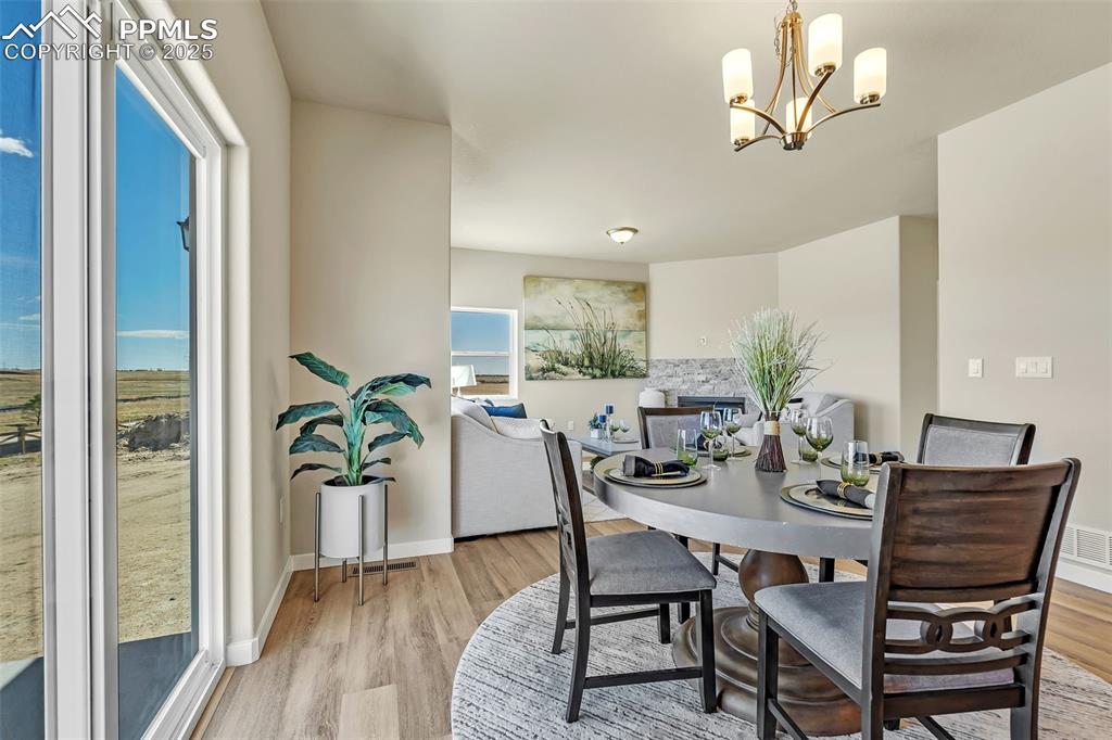 Image 14 of 46: Dining room featuring light wood-style floors and a chandelier