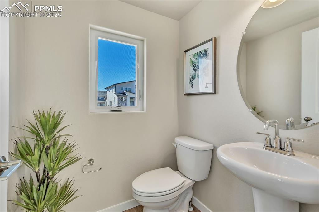 Image 23 of 46: Half bathroom featuring toilet and baseboards