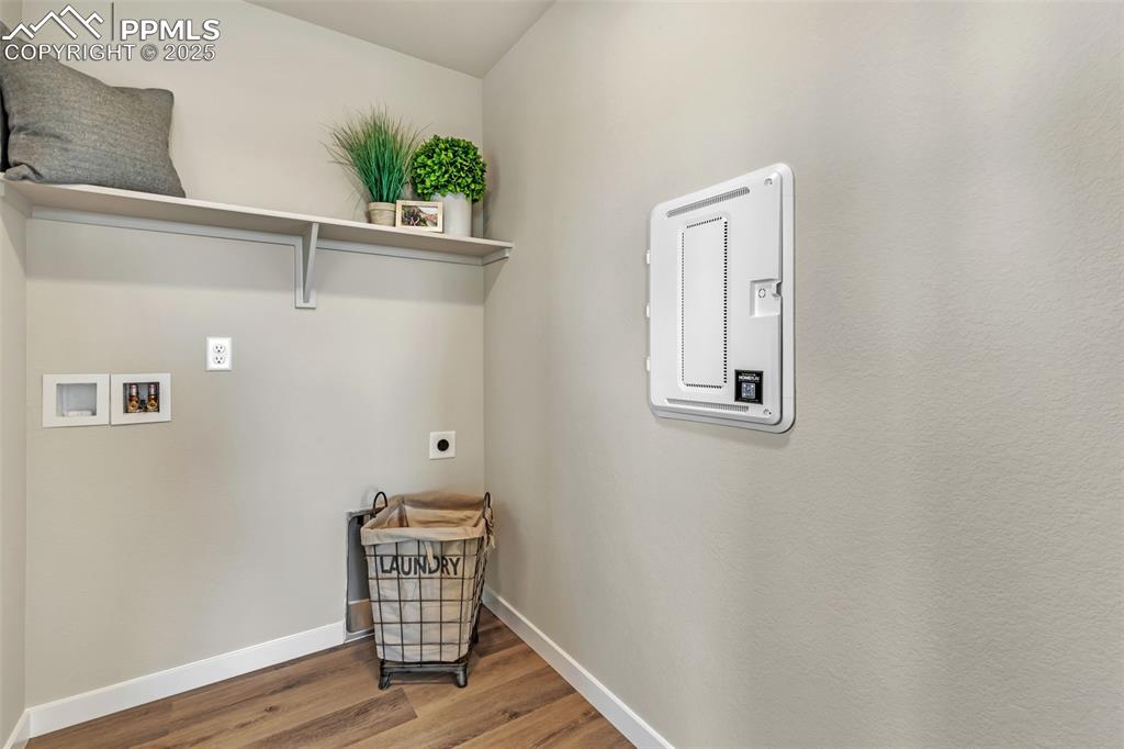 Image 25 of 46: Laundry room featuring hookup for an electric dryer, wood finished floors, 
