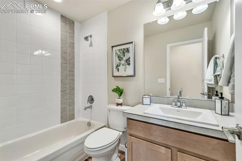 Image 35 of 46: Bathroom with shower / bath combination and vanity