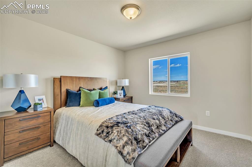 Image 38 of 46: Bedroom with light carpet and baseboards