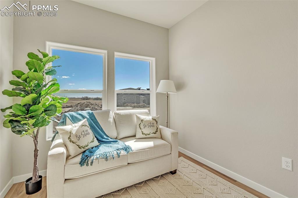Image 4 of 46: Sitting room featuring healthy amount of natural light and wood finished fl