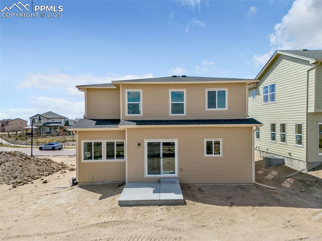 Image 44 of 46: Back of house featuring roof with shingles