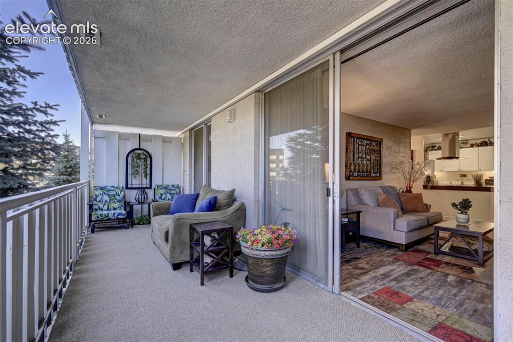 Image 12 of 33: New Carpet; The balcony is protected from weather by trees