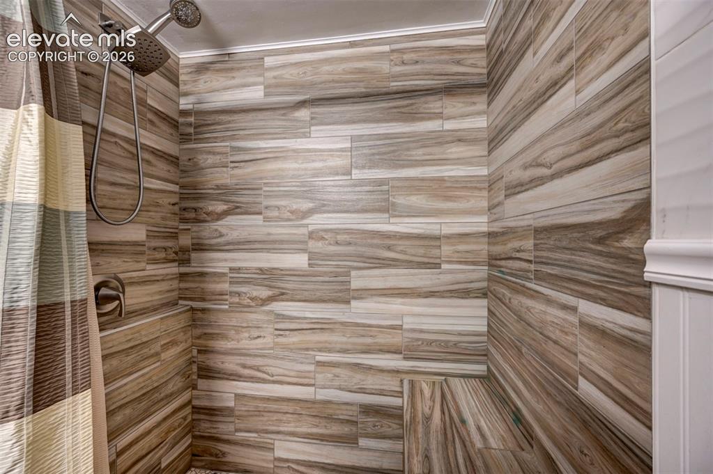 Image 20 of 33: Floor to Ceiling Tile Surround Shower