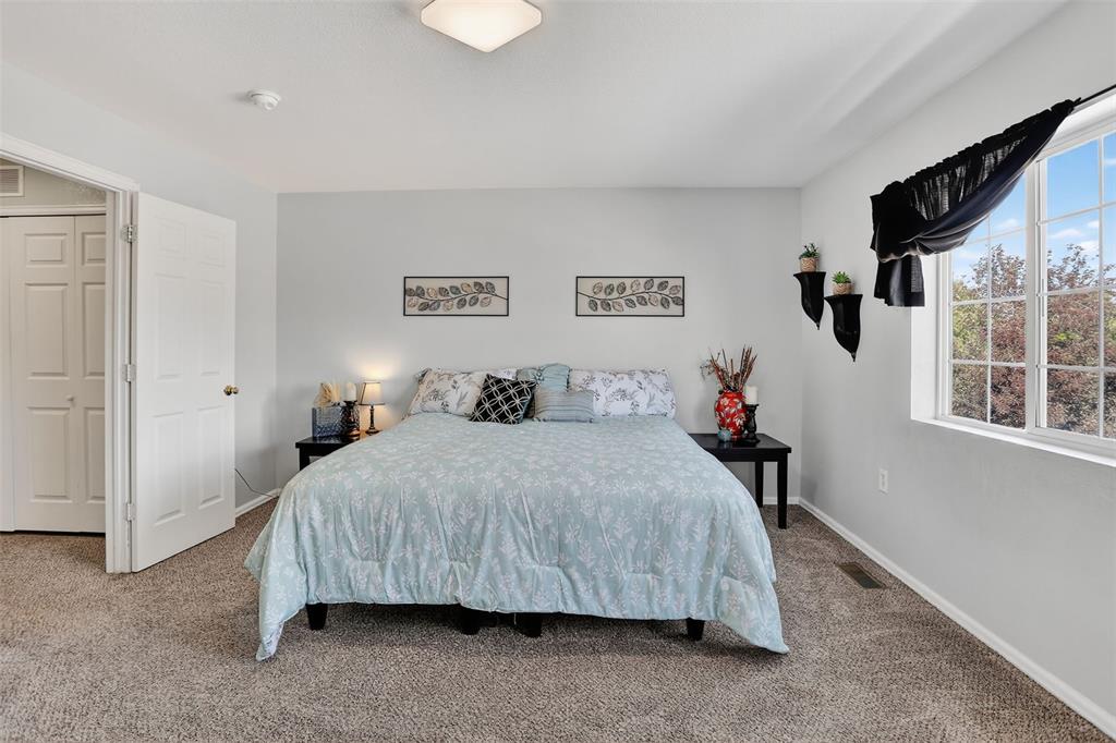 Image 24 of 42: he upper level features two spacious bedrooms, a laundry area, and a genero