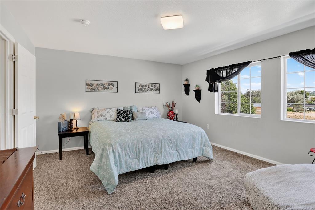 Image 25 of 42: he upper level features two spacious bedrooms, a laundry area, and a genero