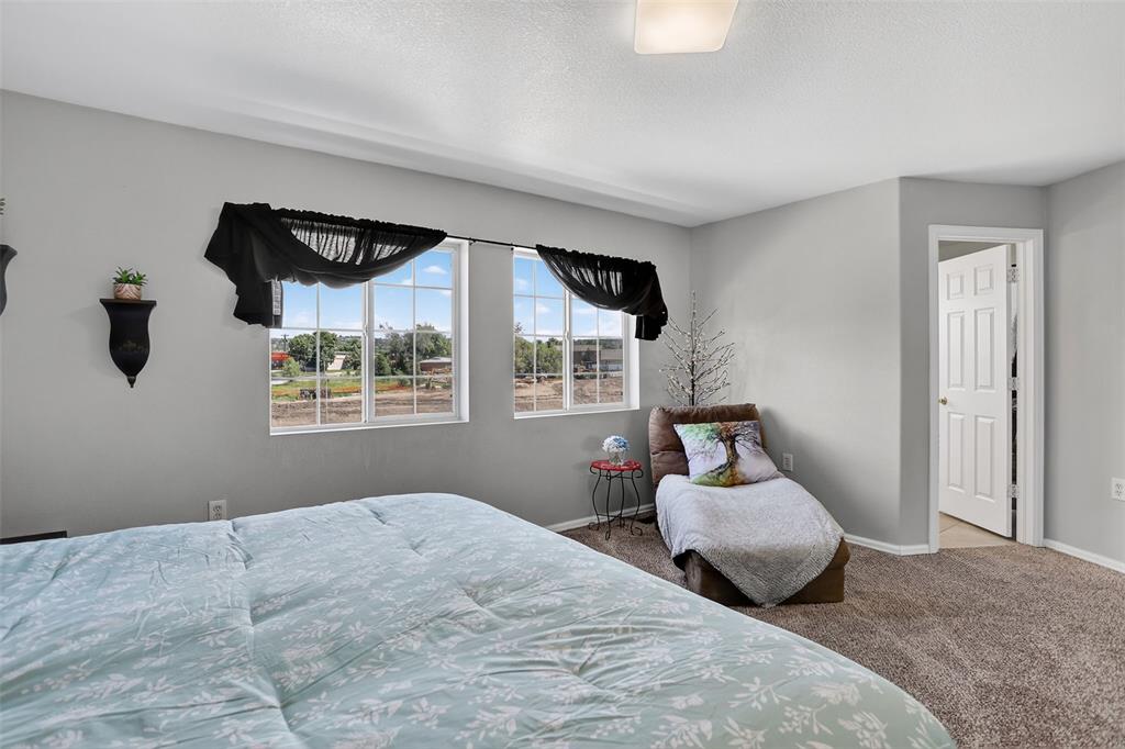 Image 28 of 42: he upper level features two spacious bedrooms, a laundry area, and a genero