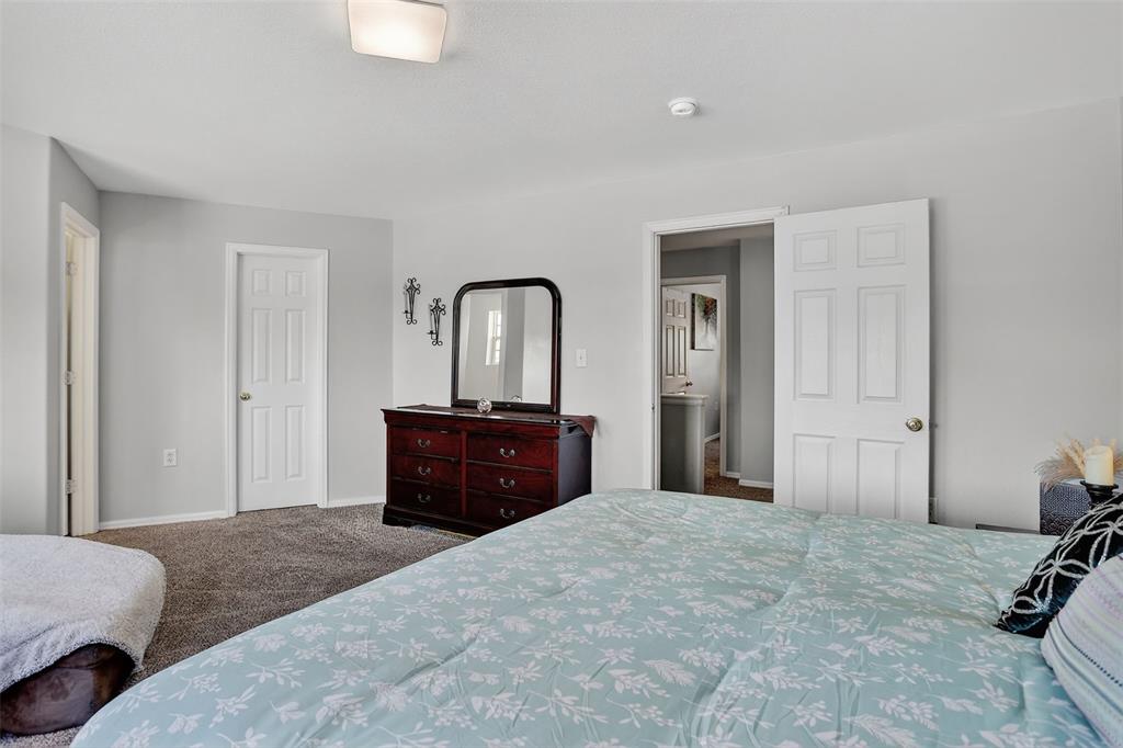 Image 29 of 42: he upper level features two spacious bedrooms, a laundry area, and a genero