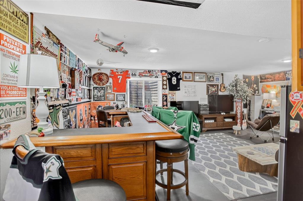 Image 31 of 42: The finished lower level adds exceptional versatility—perfect for a rec roo