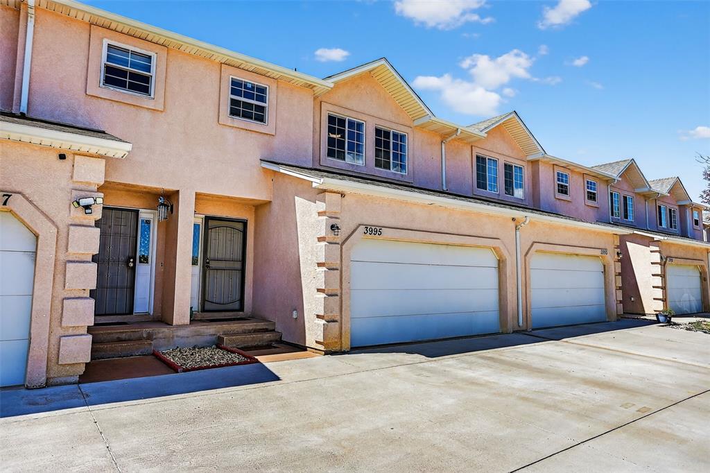 Image 4 of 42: Two car garage, stucco exterior - 2-story home in the heart of town—perfect