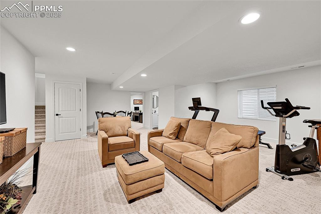 Image 22 of 36: Living area featuring recessed lighting, light carpet, and baseboards