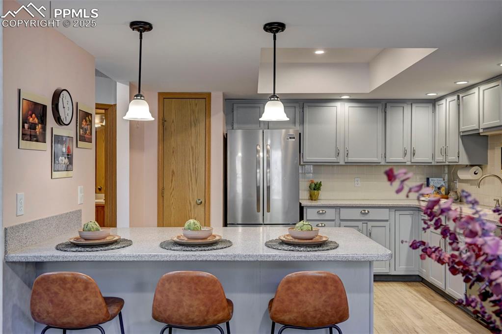 Image 11 of 43: Breakfast Bar, Updated Lighting, New Fridge