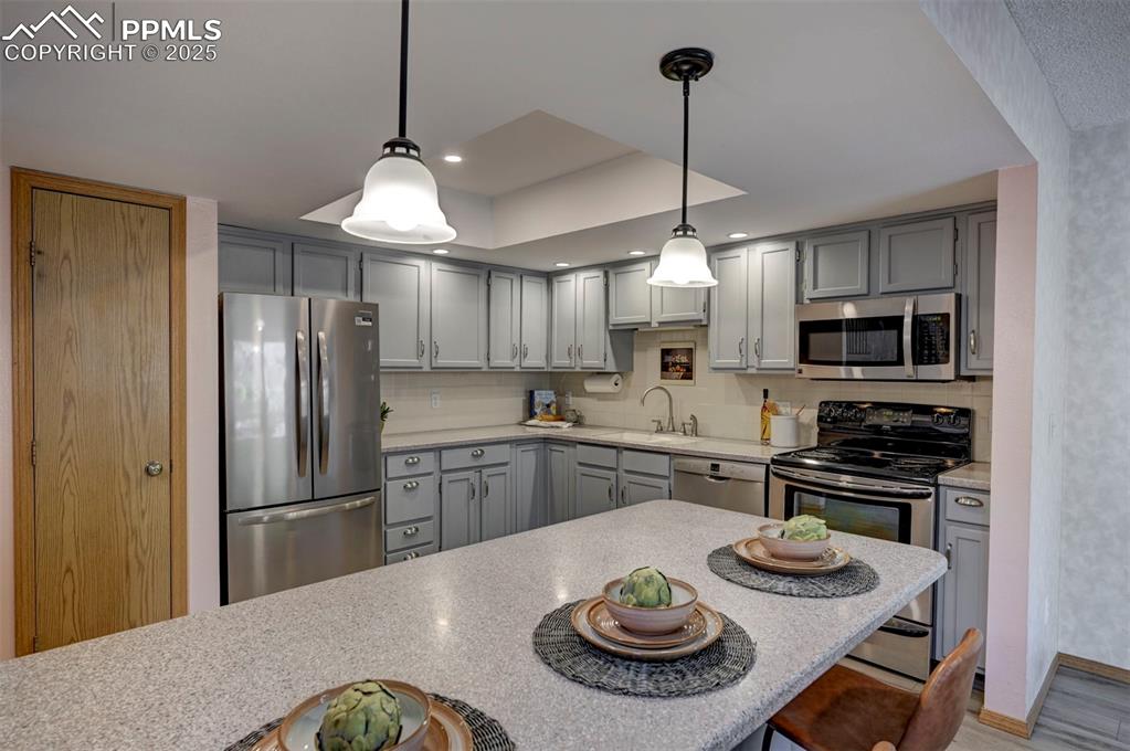 Image 12 of 43: Breakfast Bar, Updated Lighting, Built-in Microwave