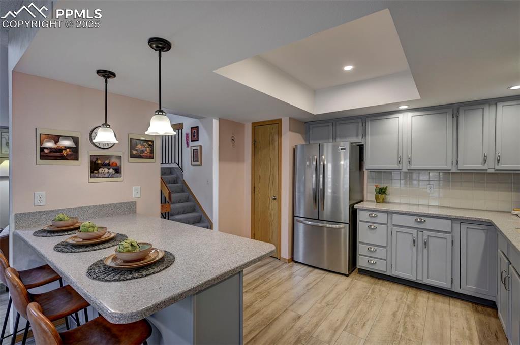 Image 13 of 43: Breakfast Bar, Updated Lighting, New Fridge