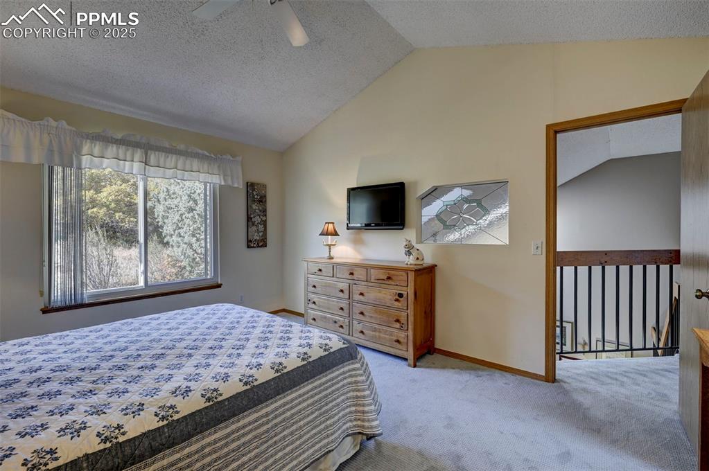 Image 22 of 43: Upper Level Primary Suite w/ Stained Glass Window