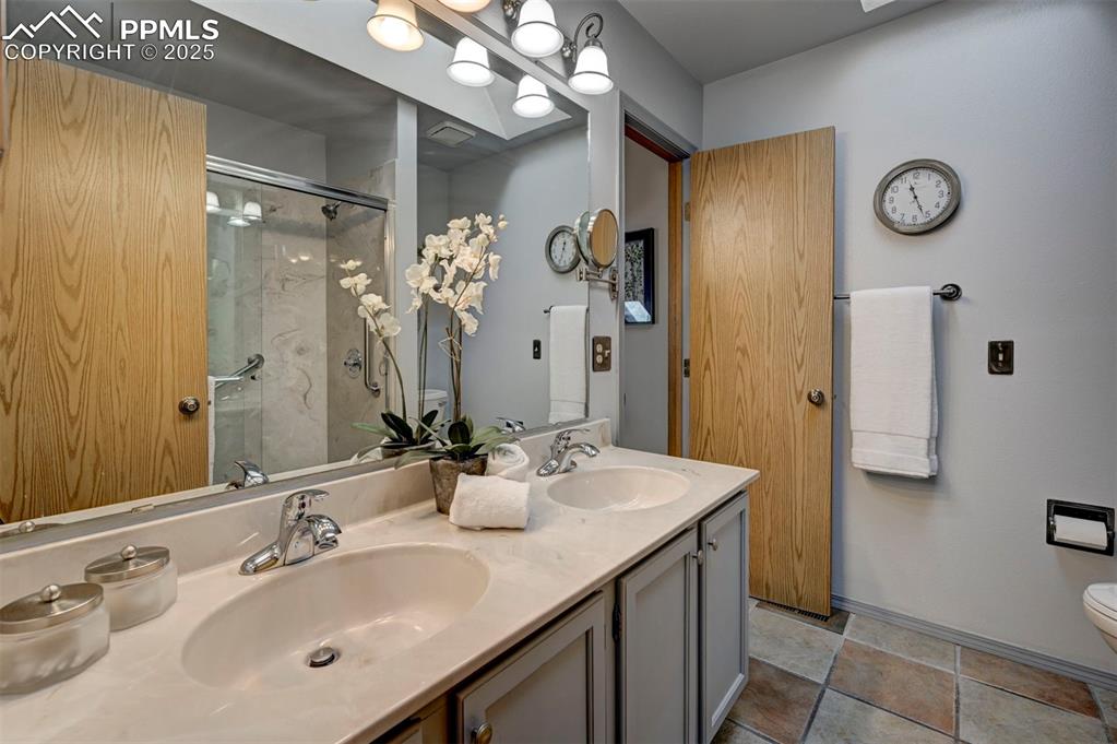 Image 24 of 43: Updated Primary ensuite w/ Walk-in Shower, Skylight, and Duel Vanity