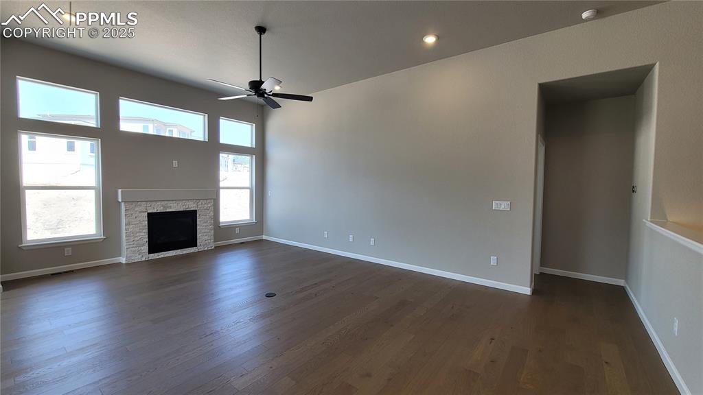 Image 5 of 23: Great Room with engineered wood flooring, floor outlet, ceiling fan, LED li