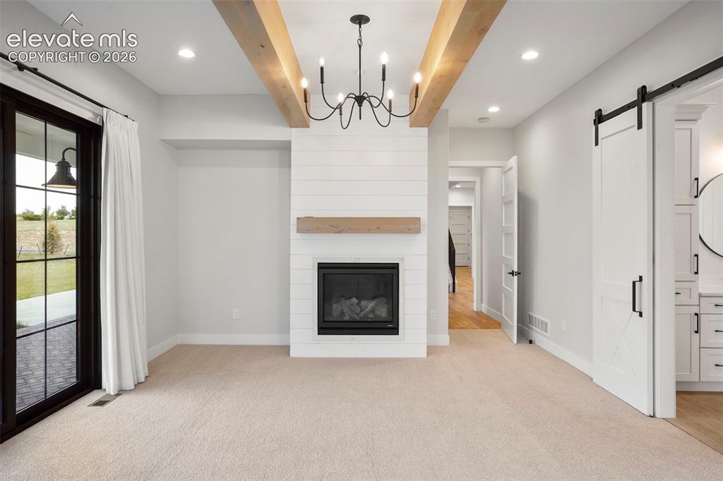 Image 17 of 49: A view of the great room/dining room towards the front entry.