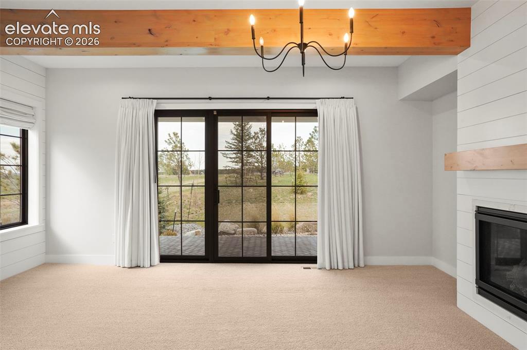 Image 20 of 49: Lots of light and function in this suite. A walk-out to the covered patio a