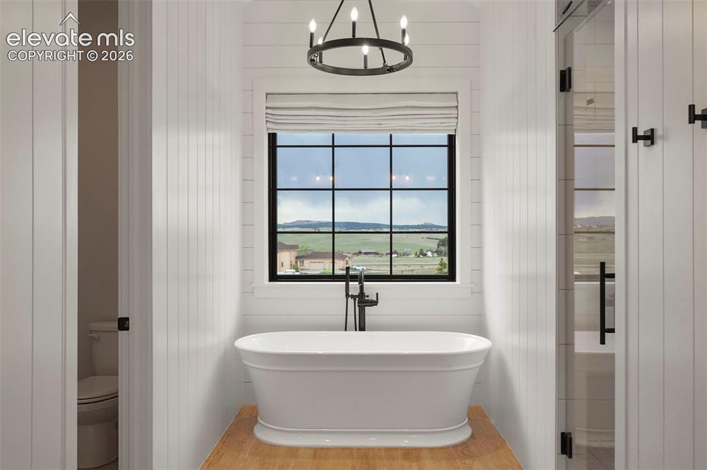 Image 23 of 49: Double vanity, storage, WC, spa shower and soaking tub make this primary en