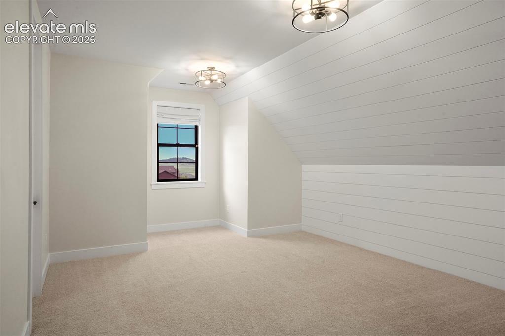 Image 38 of 49: Additional secondary bedroom with built-ins.