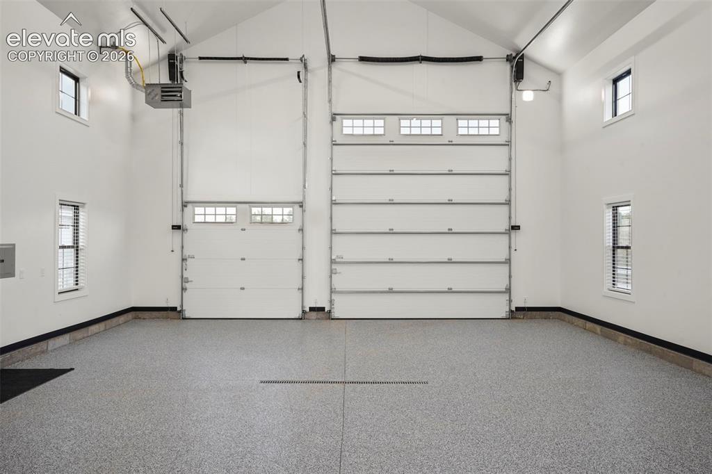 Image 44 of 49: RV garage has amazing versatility with 2 offices upstairs and room for a gy