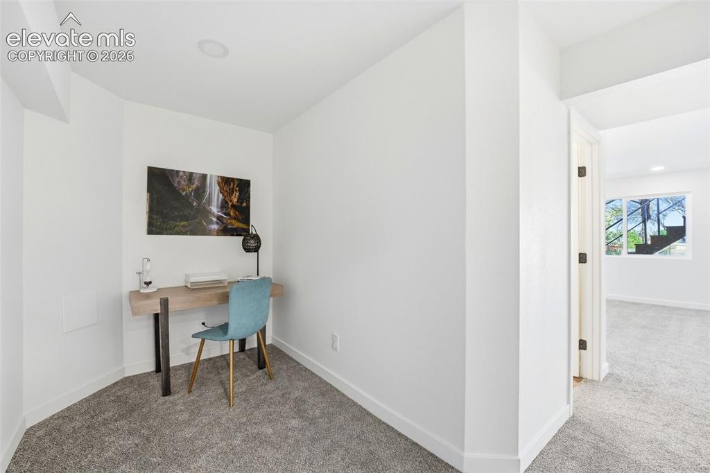 Image 13 of 36: Dedicated alcove with recessed lighting, light gray carpet, and white baseb