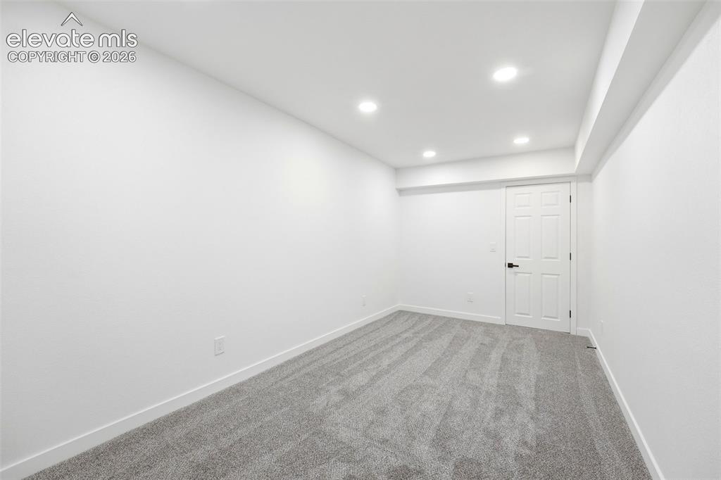 Image 16 of 36: Spacious room featuring neutral carpet flooring, recessed lighting, white t