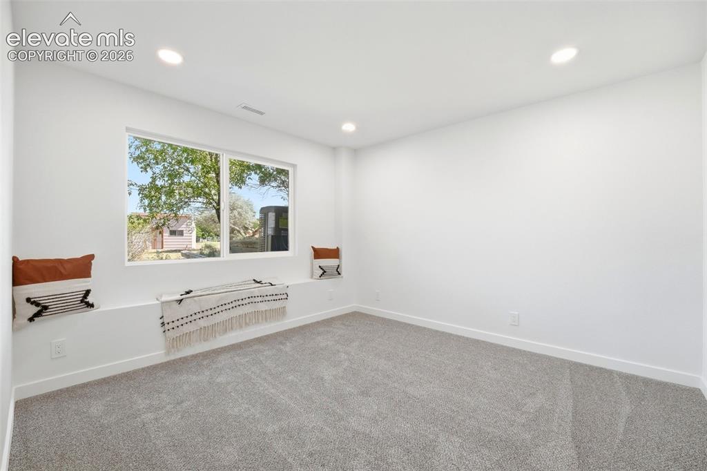 Image 21 of 36: Expansive room featuring a large window with a built-in window seat