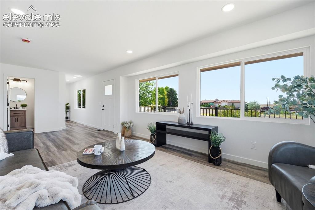 Image 29 of 36: Open-concept living space featuring wood-finish flooring, recessed lighting