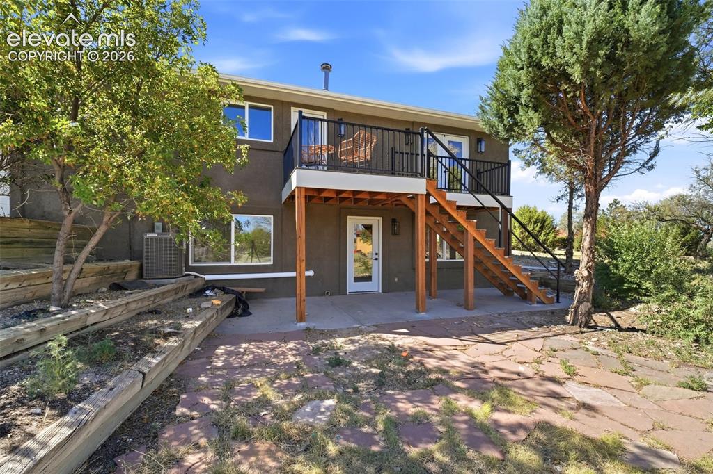 Image 31 of 36: Two-story exterior with a second-level balcony featuring black metal railin