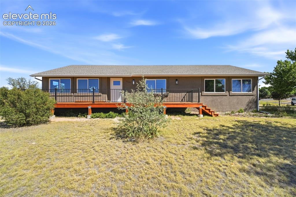 Image 34 of 36: Ranch-style residence featuring a stucco exterior, a neutral-toned roof, a