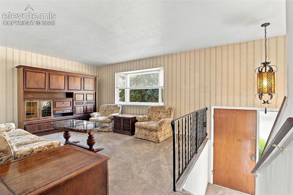 Image 11 of 42: Interior space featuring built-in wooden cabinetry, a large bay window, a m