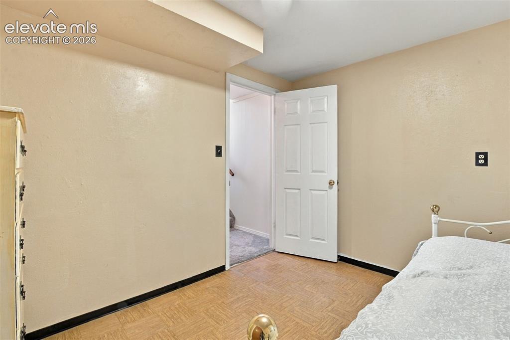 Image 25 of 42: Parquet flooring and a six-panel interior door