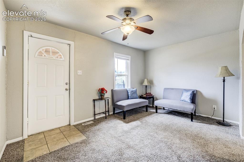 Image 10 of 46: Entry foyer featuring a white paneled door with an arched glass insert, til