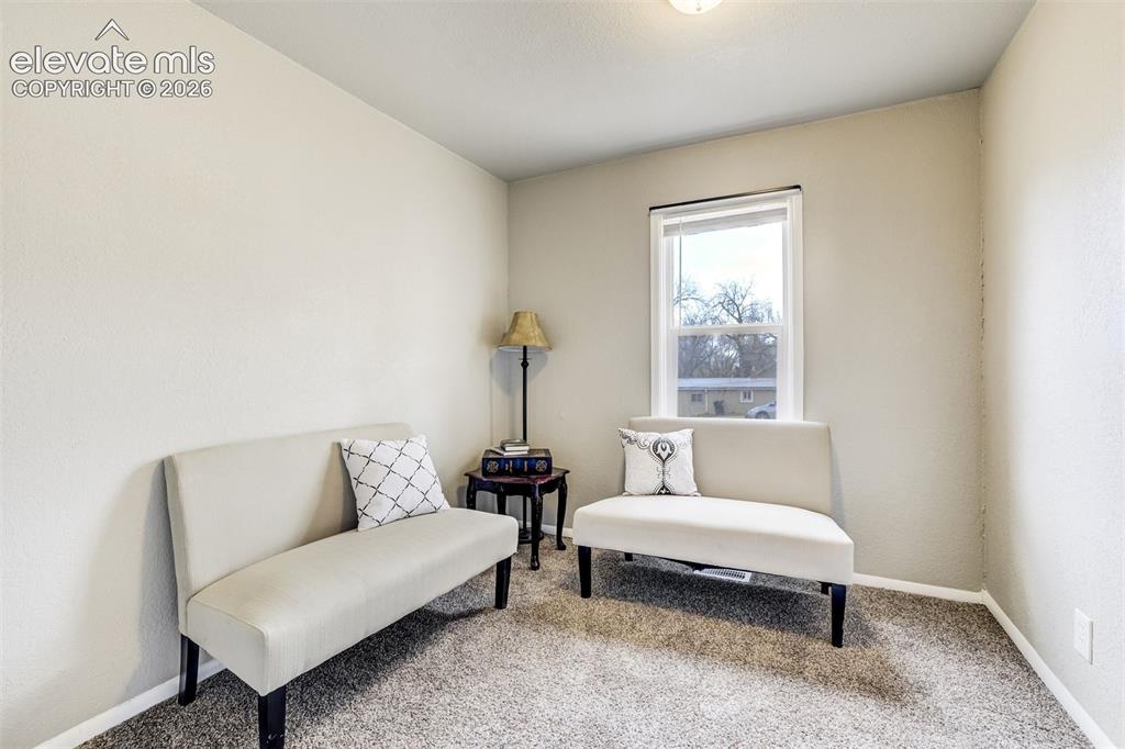 Image 27 of 46: Carpeted room featuring neutral-toned walls, a single window with dark trim