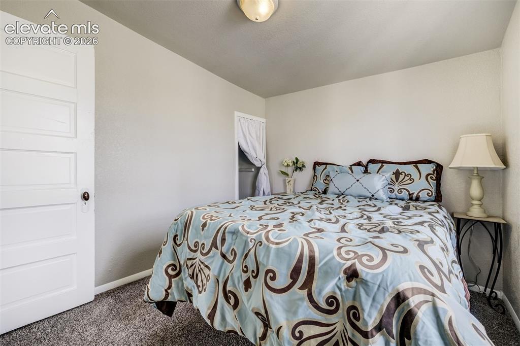 Image 34 of 46: Carpeted room featuring light-colored walls and a white paneled door