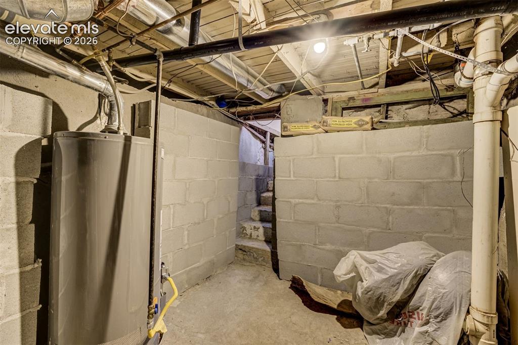 Image 40 of 46: Basement area featuring concrete block walls, exposed overhead ductwork, an
