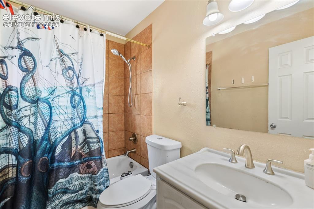 Image 11 of 23: Full bathroom with updated vanity and tub/shower combination